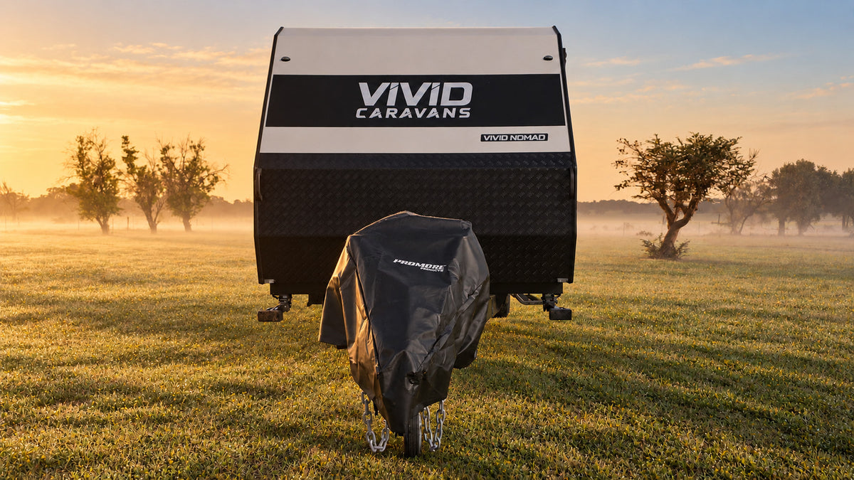 Front view of a caravan in a misty paddock at sunrise with the black Promore Products hitch cover fitted over the hitch and gas bottles