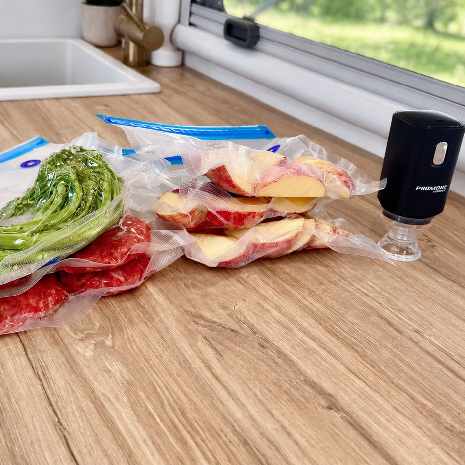 Vacuum sealed meat, greens and fruit on a caravan bench with the Promore portable vacuum sealer
