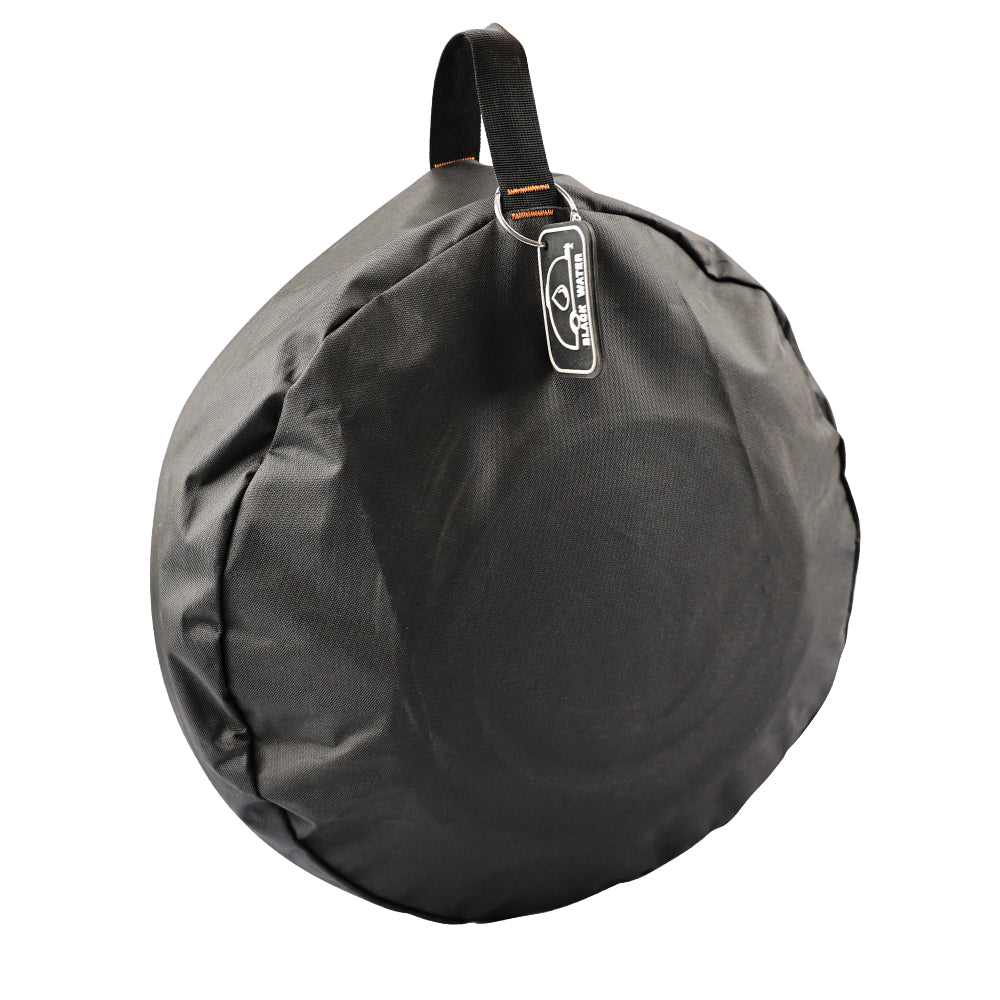 Black caravan storage bag from the side showing its round shape and carry handle