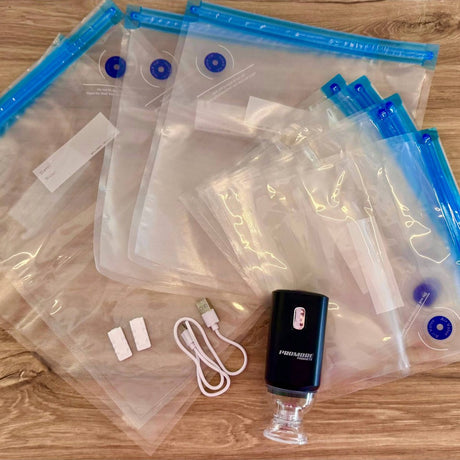 Promore Products Portable Vacuum Sealer laid out with 2 sealing clips, a USB-C charging cable and resealable vacuum bags