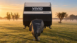 Front view of a caravan in a misty paddock at sunrise with the black Promore Products hitch cover fitted over the hitch and gas bottles