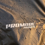 Water beading and running off the black PVC fabric beside the Promore Products logo in warm morning light