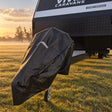 Hitch cover fitted and strapped down on the front of a caravan in a misty paddock at sunrise