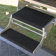 Black marine carpet step rugs fitted to a galvanised double pull out caravan step, showing the deep top tread and narrow bottom tread