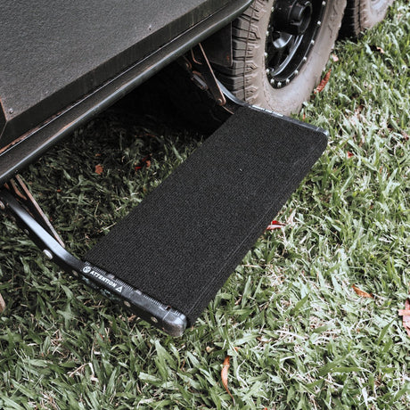 Black marine carpet step rug fitted to a single pull out caravan step