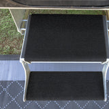 Galvanised double caravan step from above with rugs fitted, showing a deep top tread and a narrow bottom tread