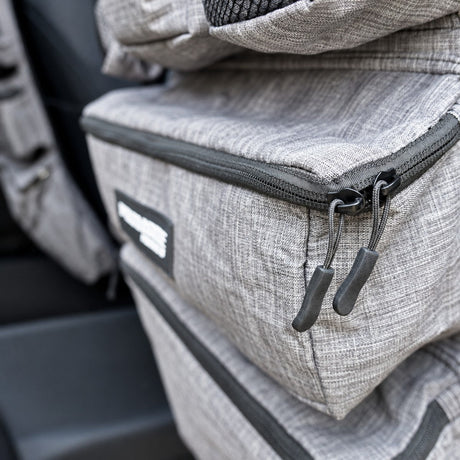 Close up of the zipped lower pocket and logo patch on the Promore Products Premium Car Seat Organiser