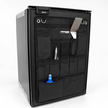 Angled view of the Promore Products Upright Fridge Organiser Large on an upright fridge door with utensils in the pockets