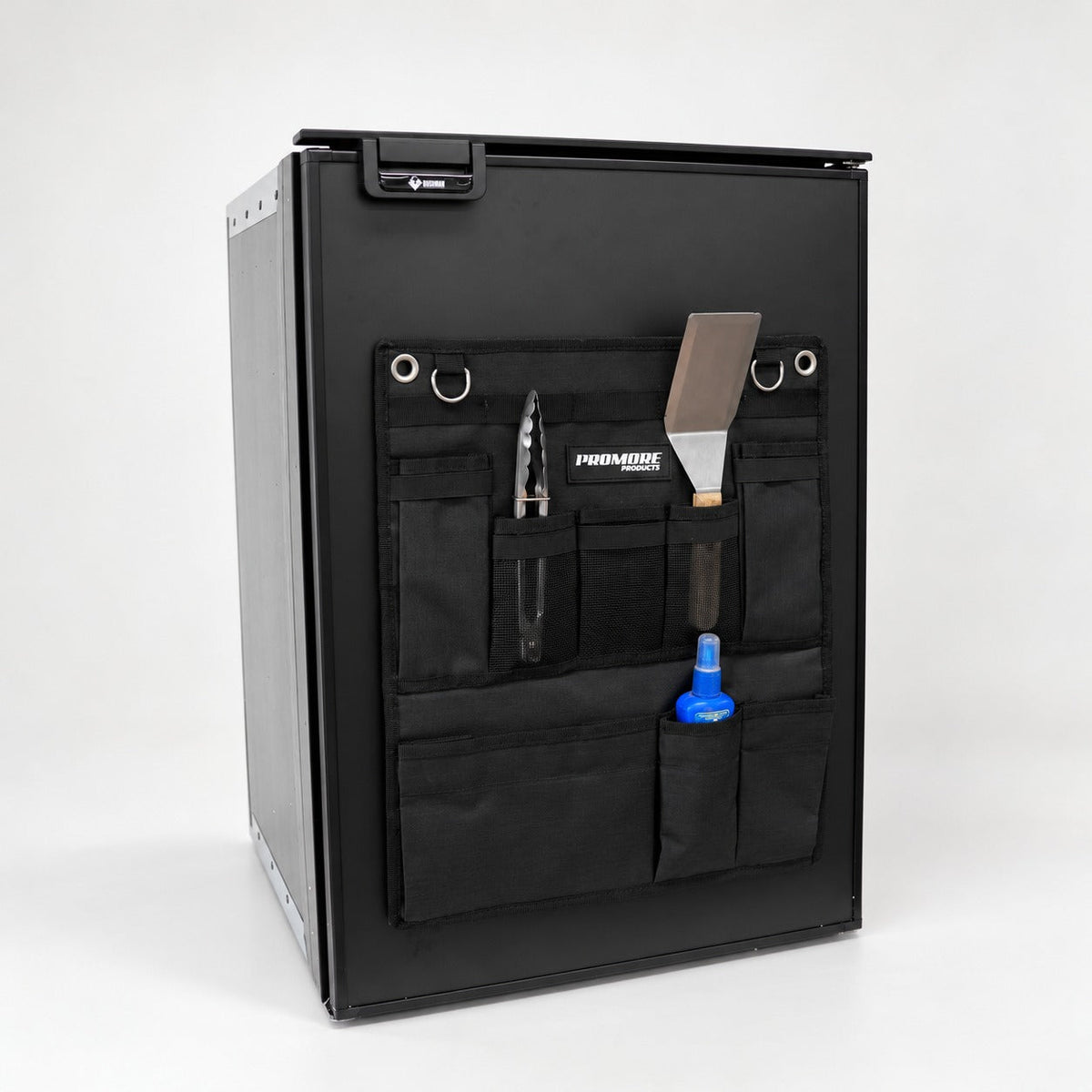 Angled view of the Promore Products Upright Fridge Organiser Small on an upright fridge door with utensils in the pockets