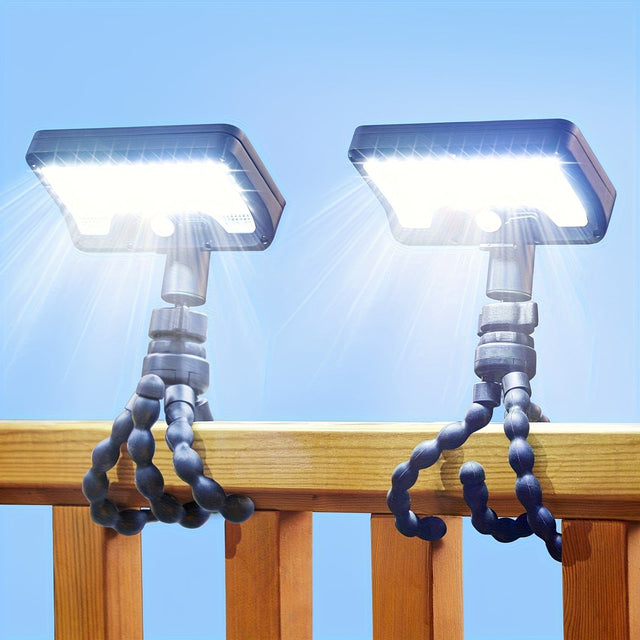 Pack of 2 solar motion sensor camping lights with flexible tripod legs wrapped around a timber deck rail