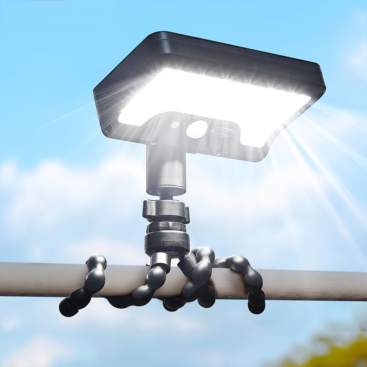 Solar motion sensor camping light with flexible octopus tripod legs wrapped around a pole
